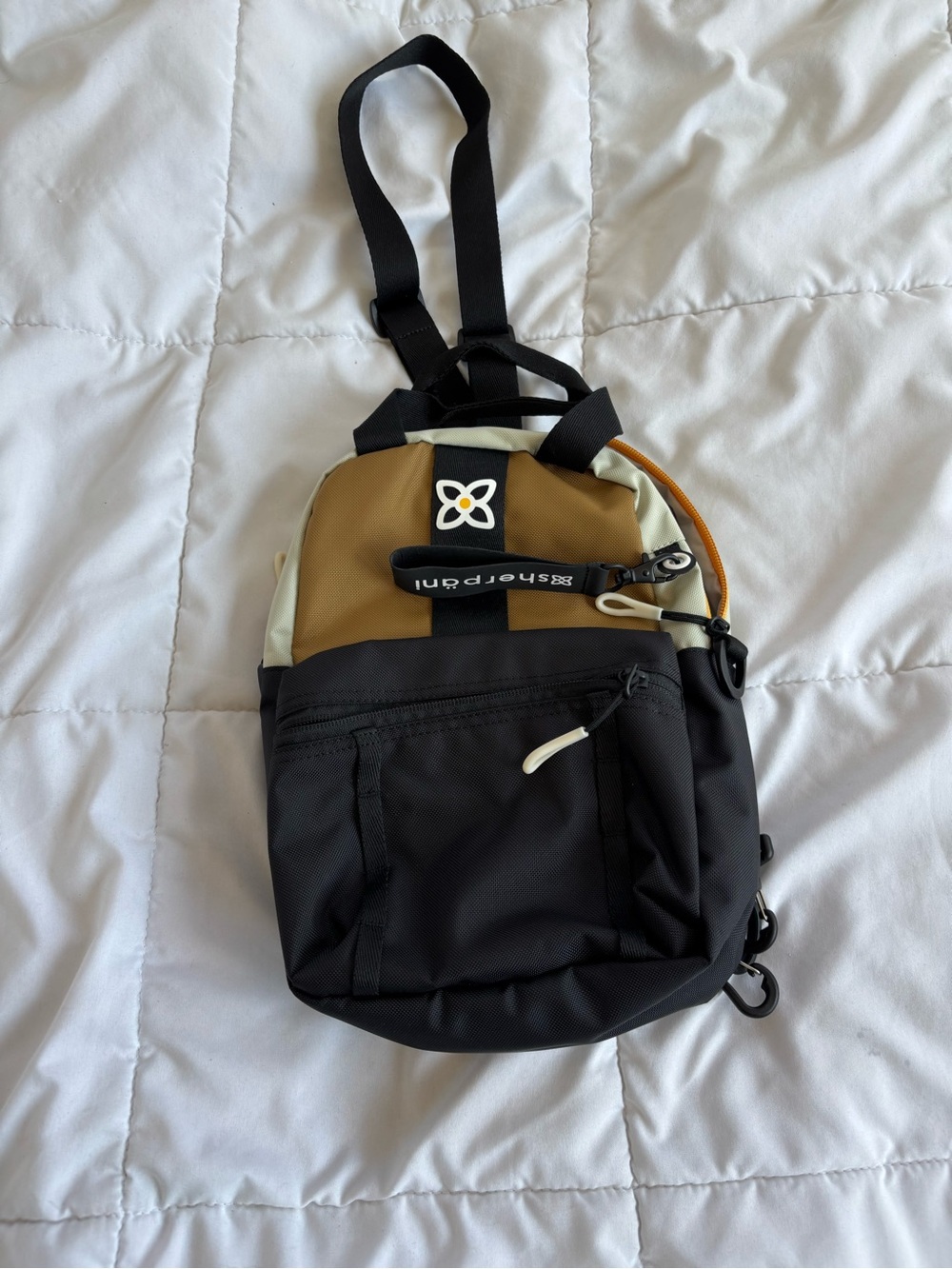 Sherpani Black and Brown Mini Sling Backpack with Cream Accents